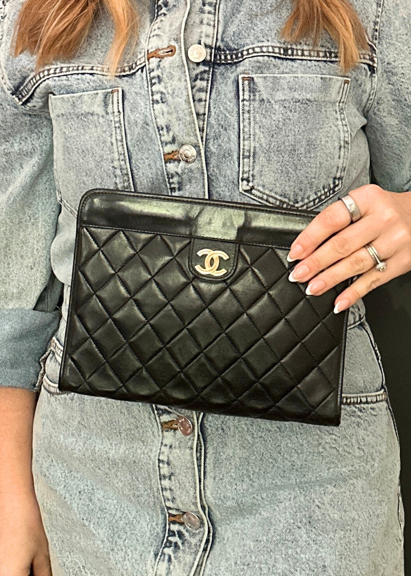Person Holding a vintage quilted leather Chanel clutch