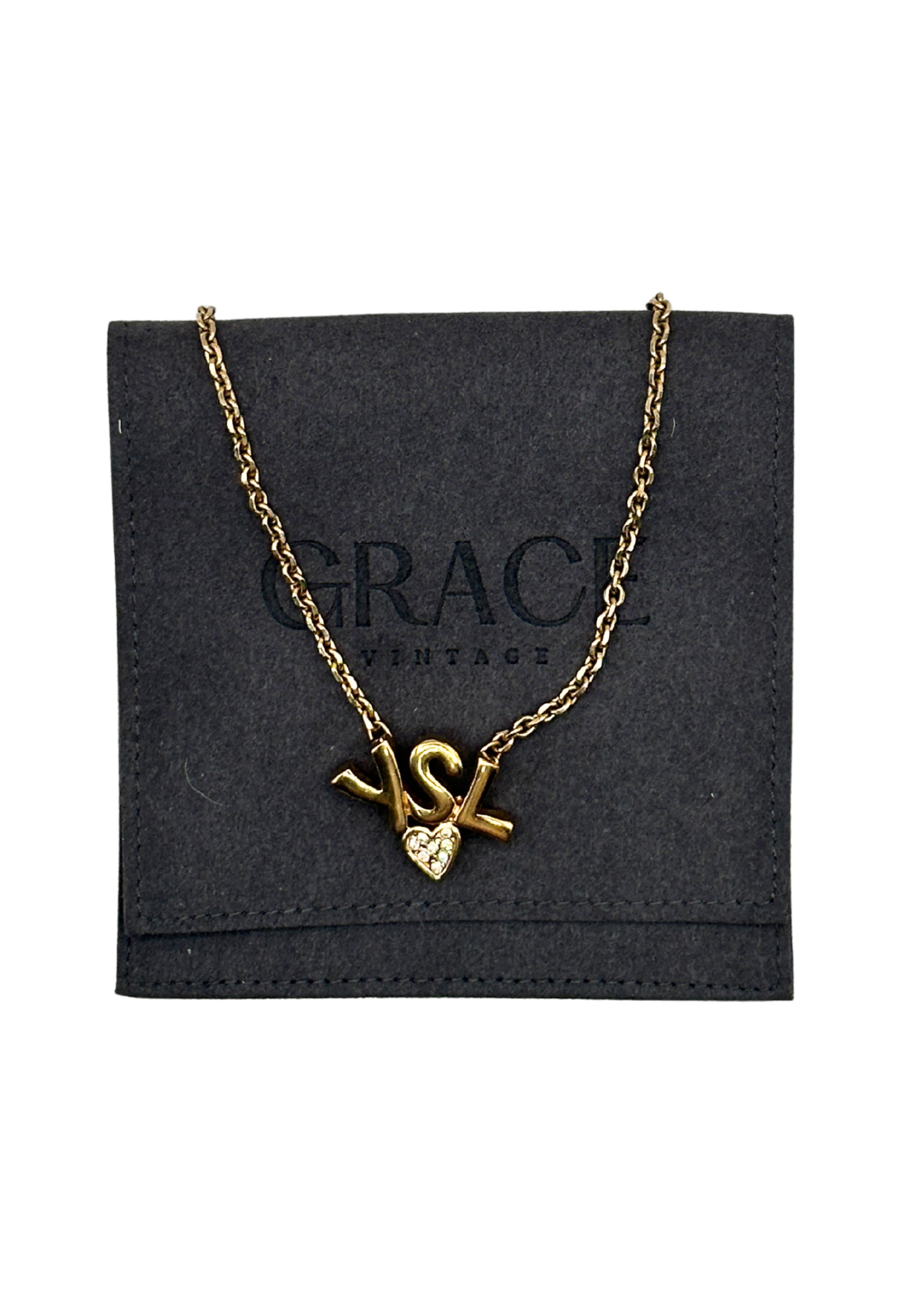 Gold vintage YSL necklace with heart pendant on a black 'GRACE' branded card