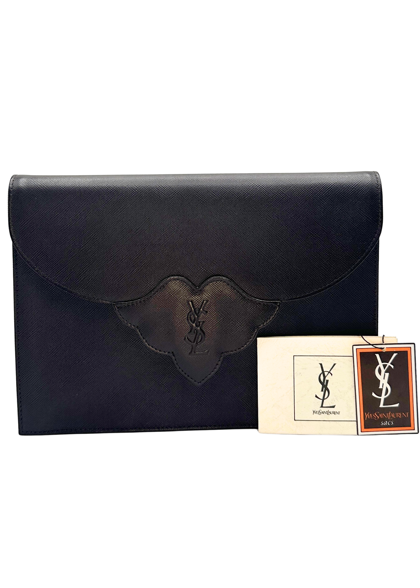 Brown leather clutch with Yves Saint Laurent logo and tags on a white background