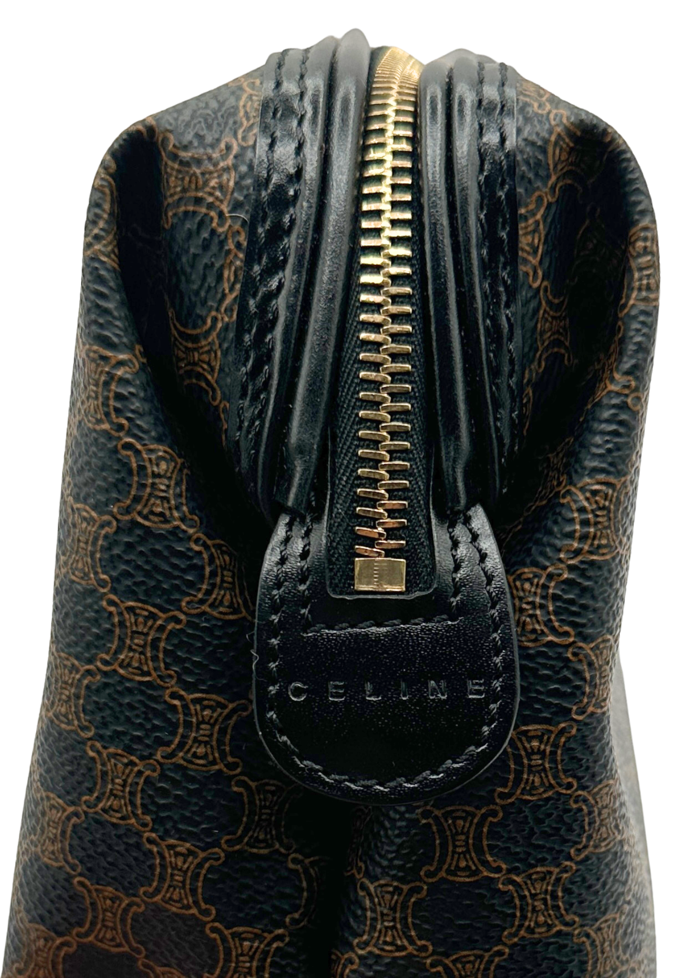 Patterned handbag with gold zipper and 'Celine' branding on a white background
