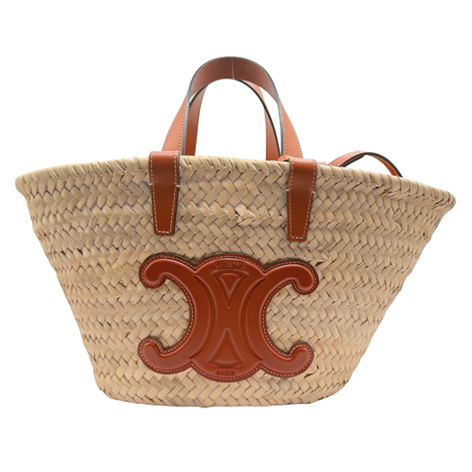 Woven straw Celine bag with brown leather triomphe accents on a white background