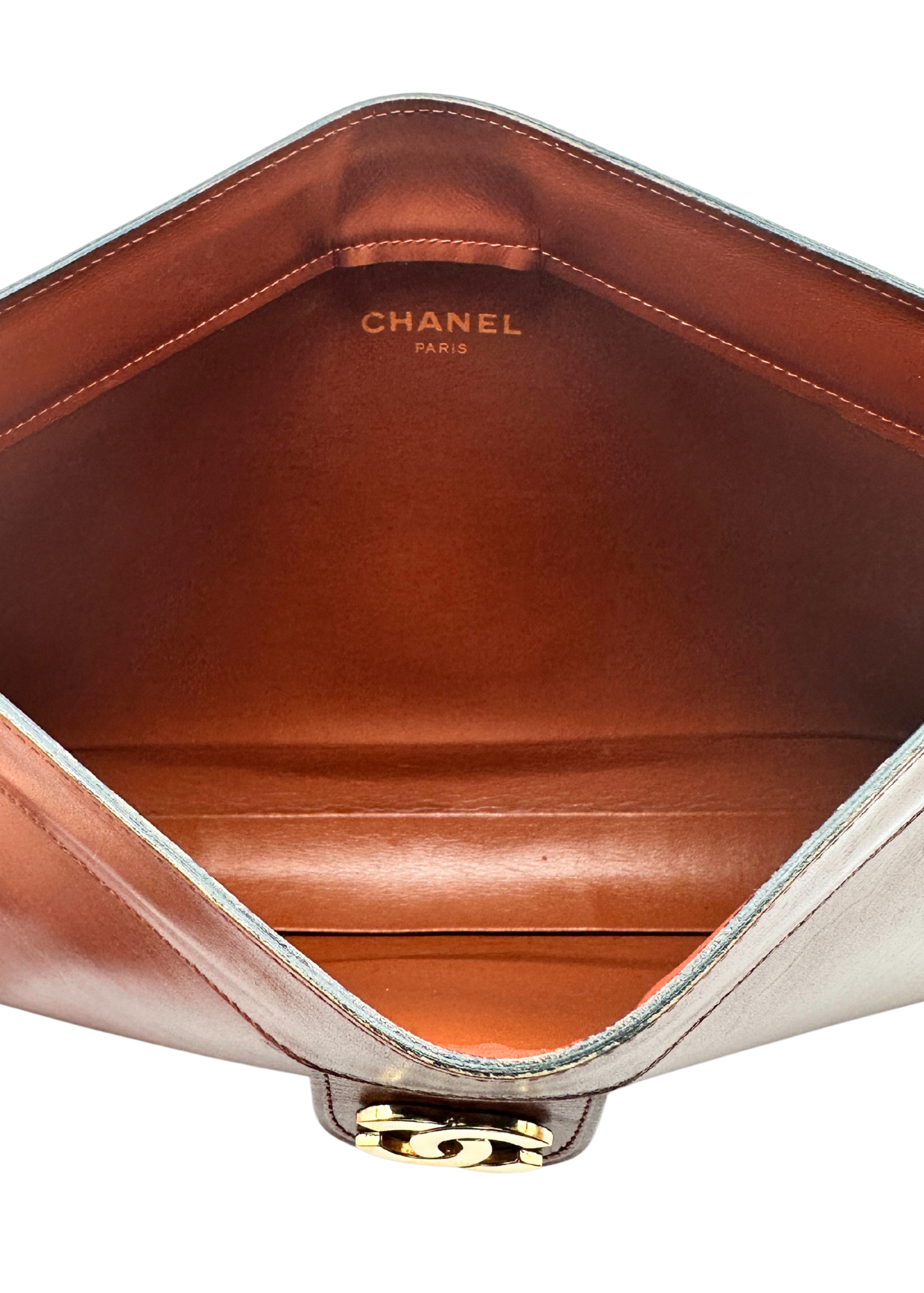 Close-up of a Chanel handbag with visible branding on a white background