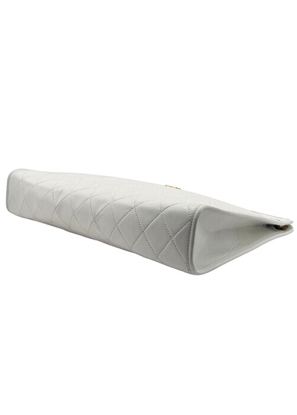 White vintage Chanel quilted clutch corner detail on white background