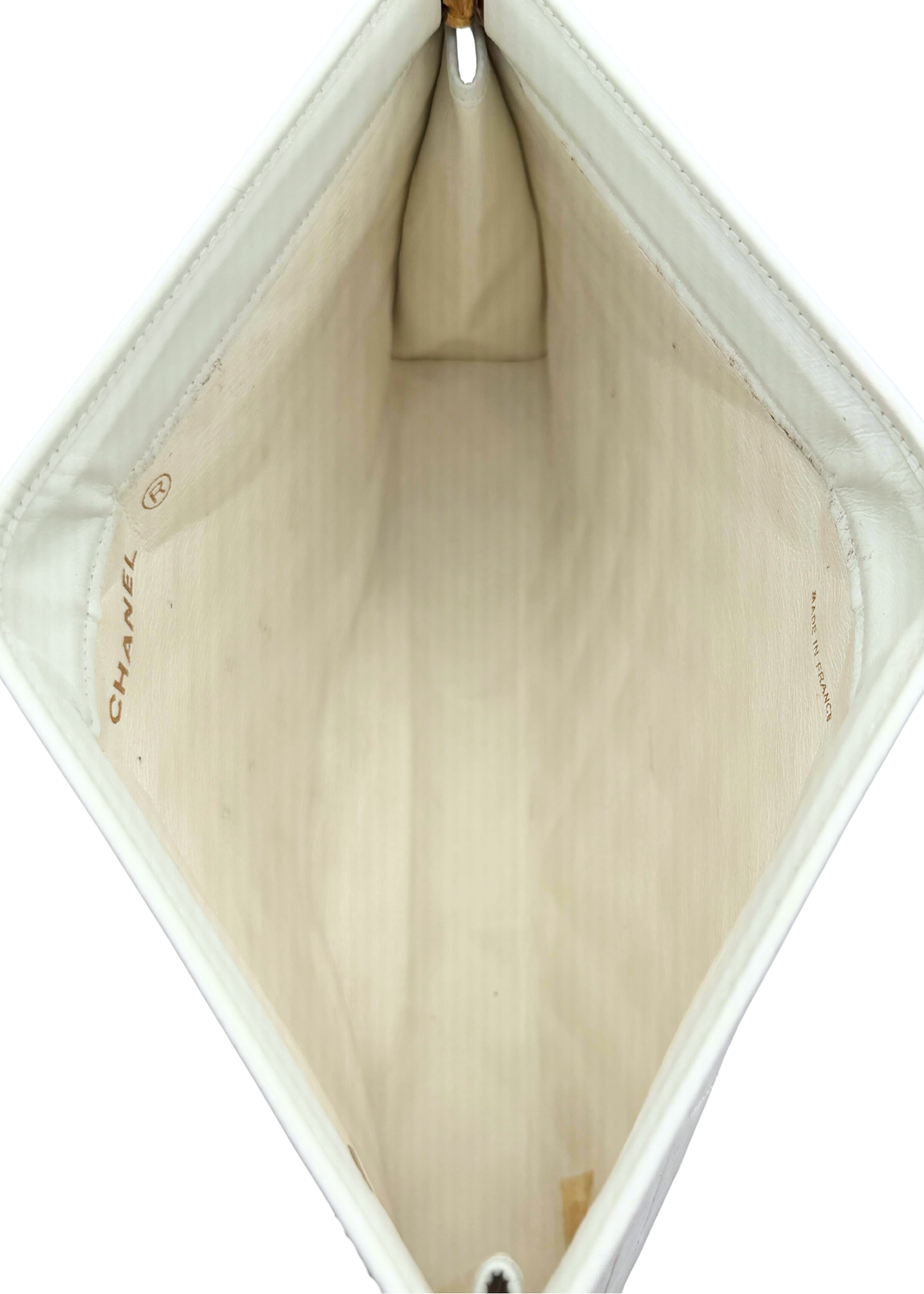 Close-up of a Chanel vintage clutch handbag interior with visible branding.