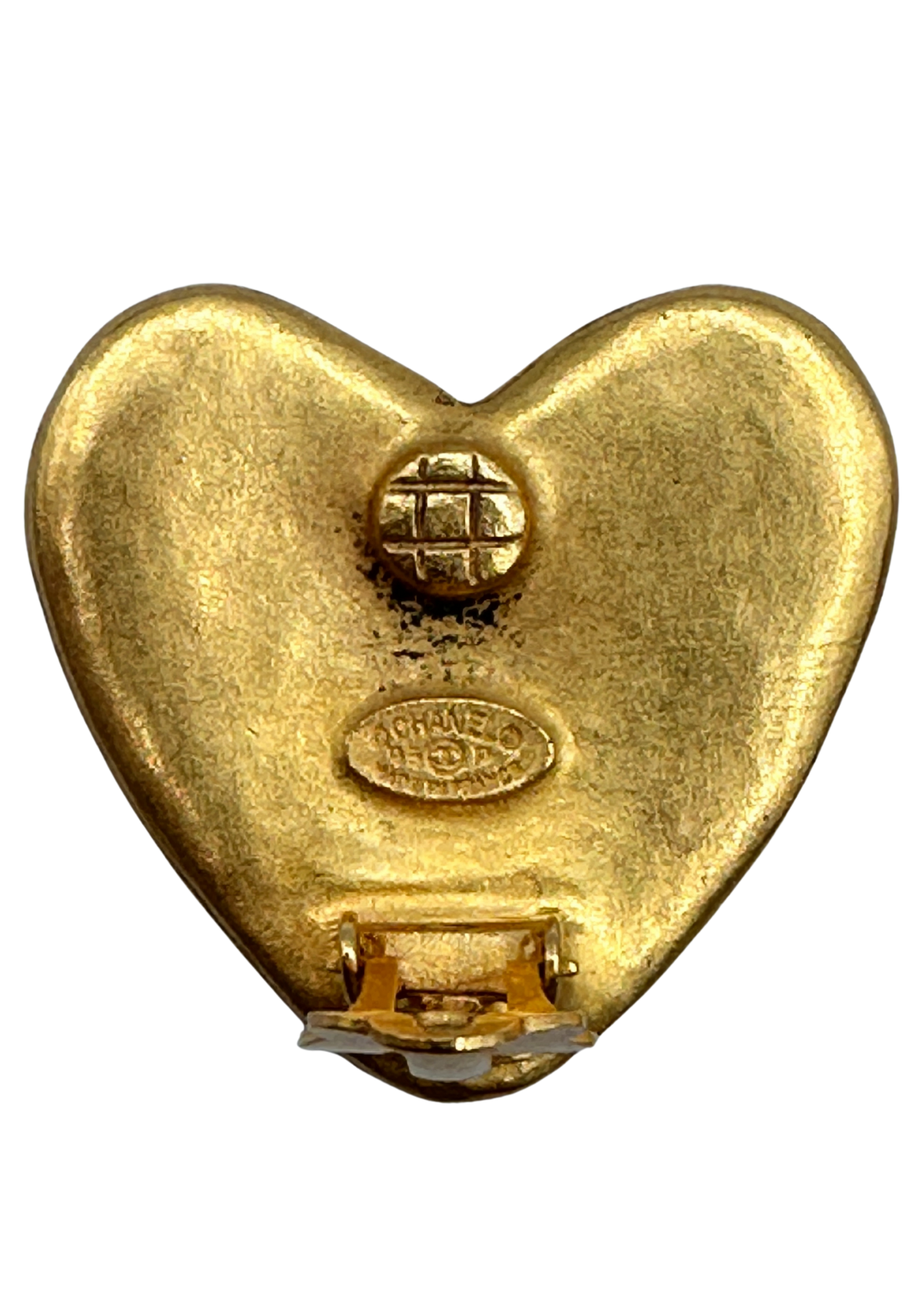 Gold heart-shaped Chanel earrings with a visible brand logo on a white background