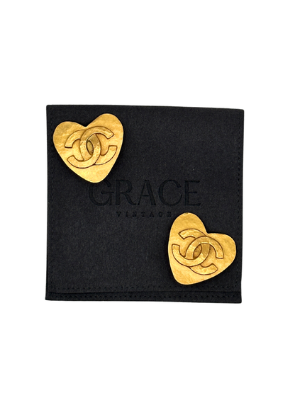 Gold heart-shaped vintage Chanel earrings on a black card with 'Grace Vintage' branding.
