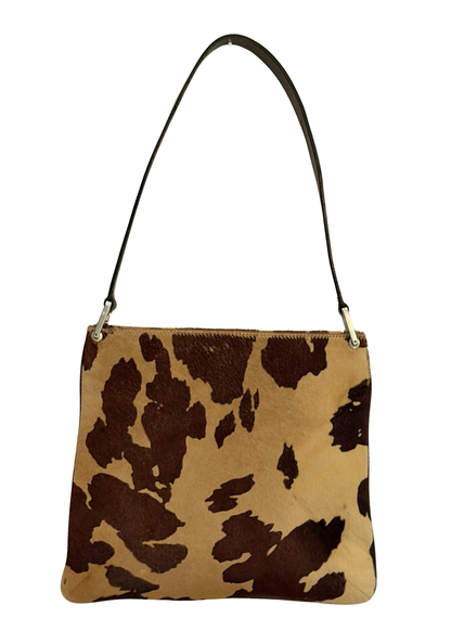 Cow print vintage Fendi handbag with a brown strap on a white background
