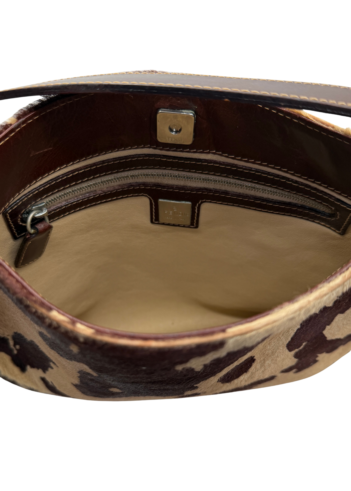 Close up of interior of vintage Fendi cow print shoulder bag