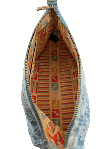 A close-up of a Fendi zippered pouchette or clutch shown open, featuring a light blue distressed denim-like exterior and a warm beige interior lined with orange, red, and blue striped pattern and Fendi FF logos.