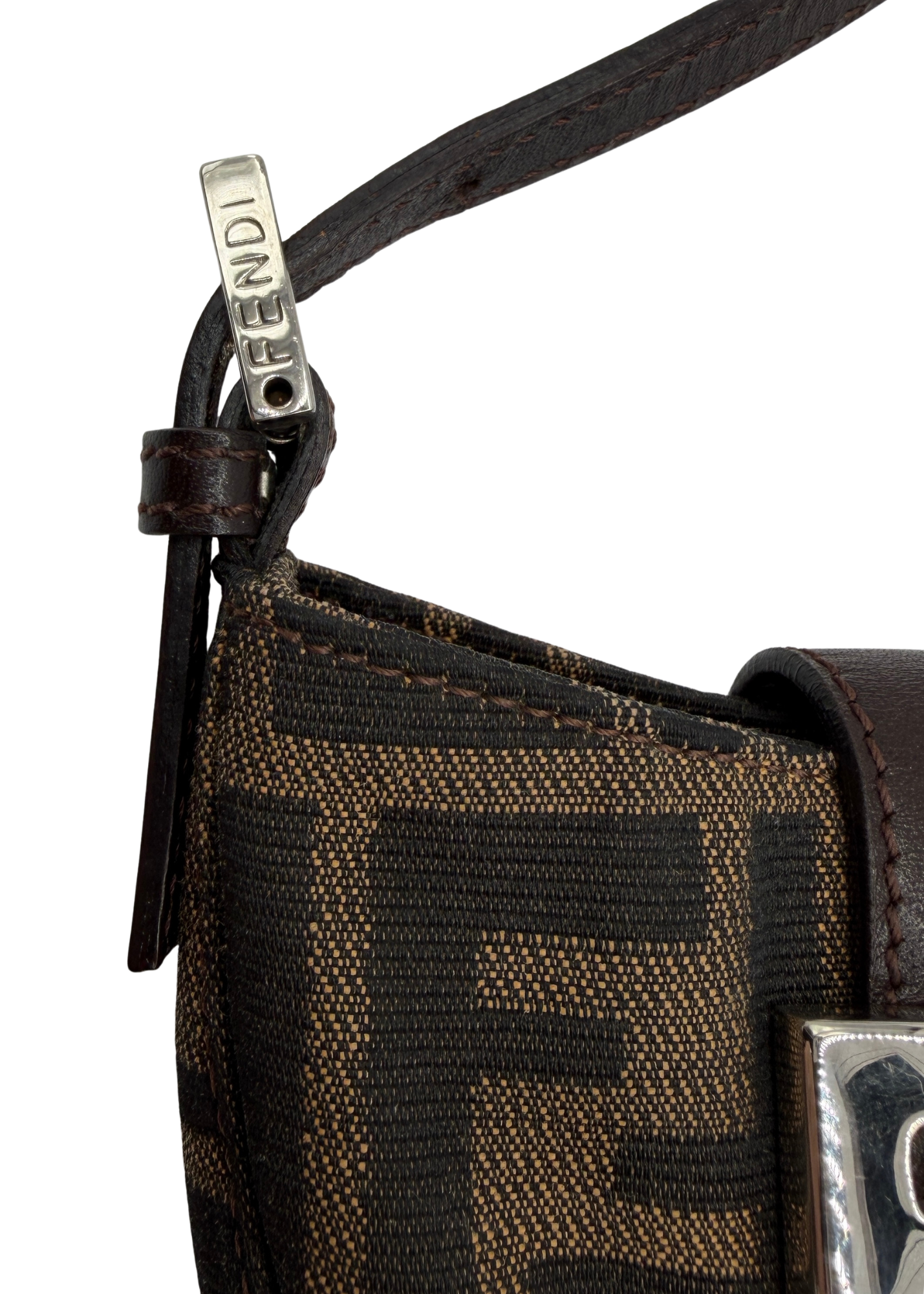 Close-up of a brown Zucca fabric and a visible Fendi brand logo on a white background.