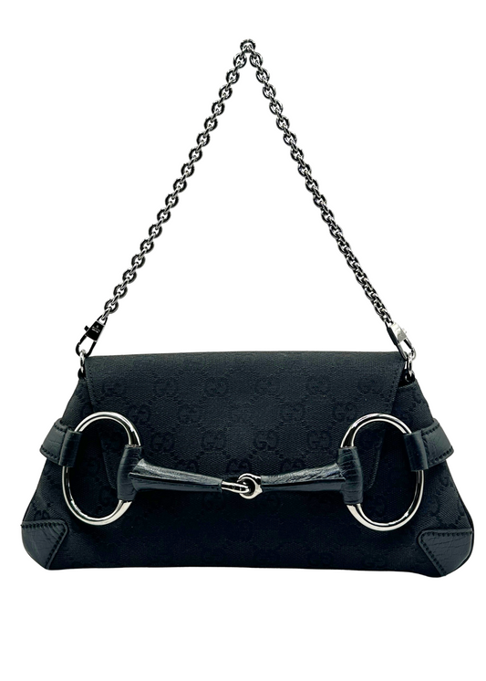 Black Gucci handbag with chain strap on a white background
