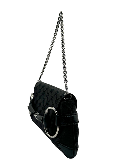 Black Gucci handbag with chain strap on a white background