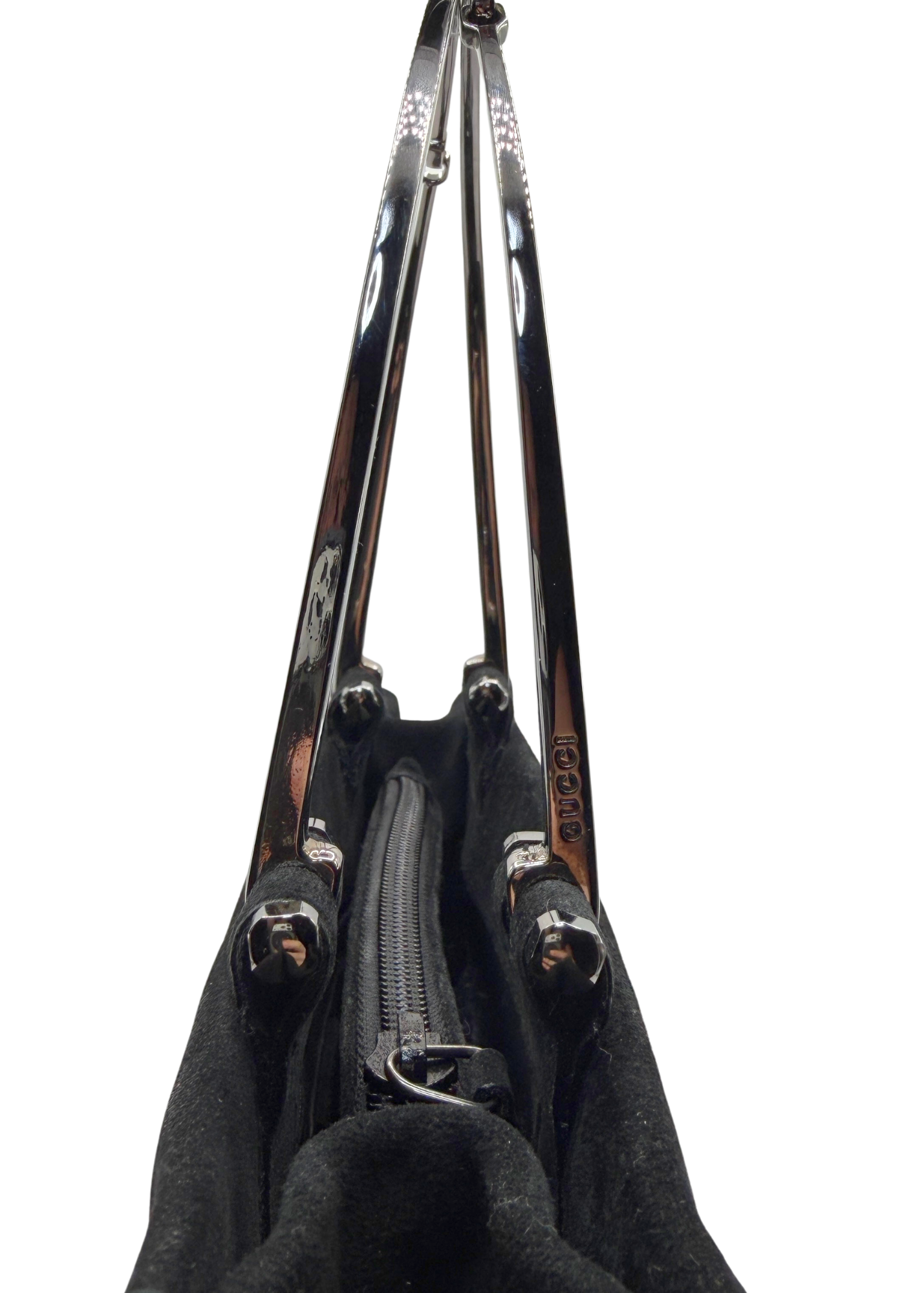 A close-up view of a black handbag showing the interior zipper compartment and two silver metal horsebit handles with silver-tone hardware, isolated on a white background.