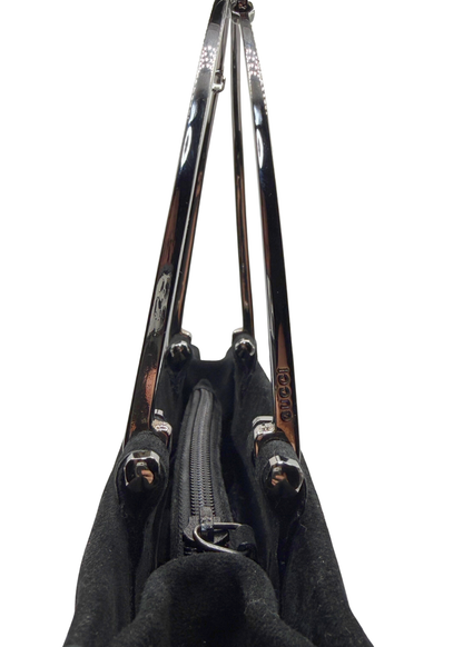 A close-up view of a black handbag showing the interior zipper compartment and two silver metal horsebit handles with silver-tone hardware, isolated on a white background.