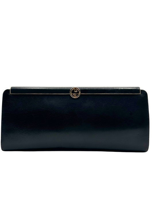 Gucci black clutch bag with a gold clasp on a white background