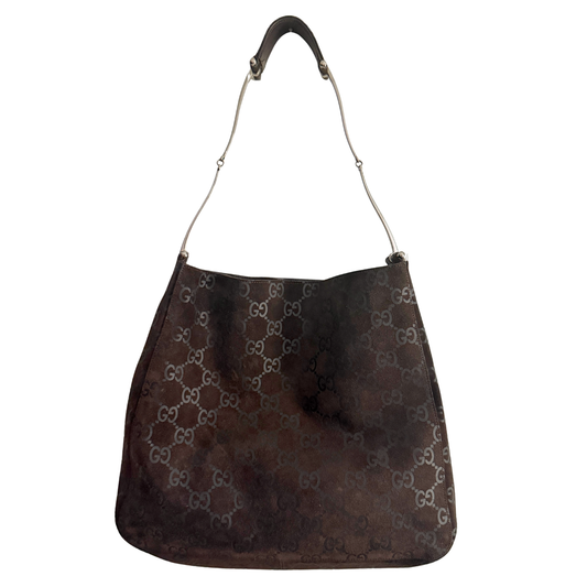 A dark brown Gucci hobo shoulder bag featuring the signature GG monogram pattern in a lighter brown and silver, with a thin silver-tone metal shoulder strap.
