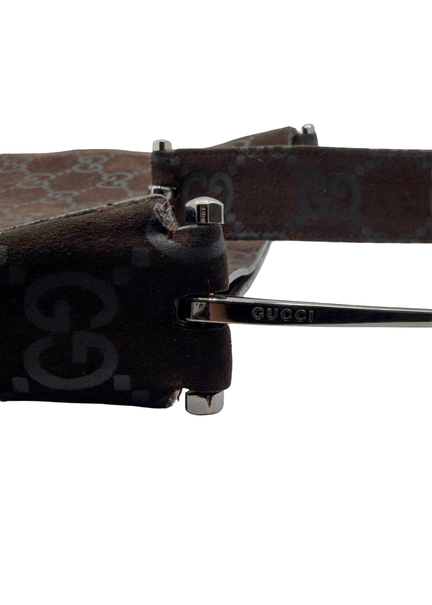 Close-up of Gucci shoulder bag showing GUCCI logo engraved in silver horsebit shoulder strap