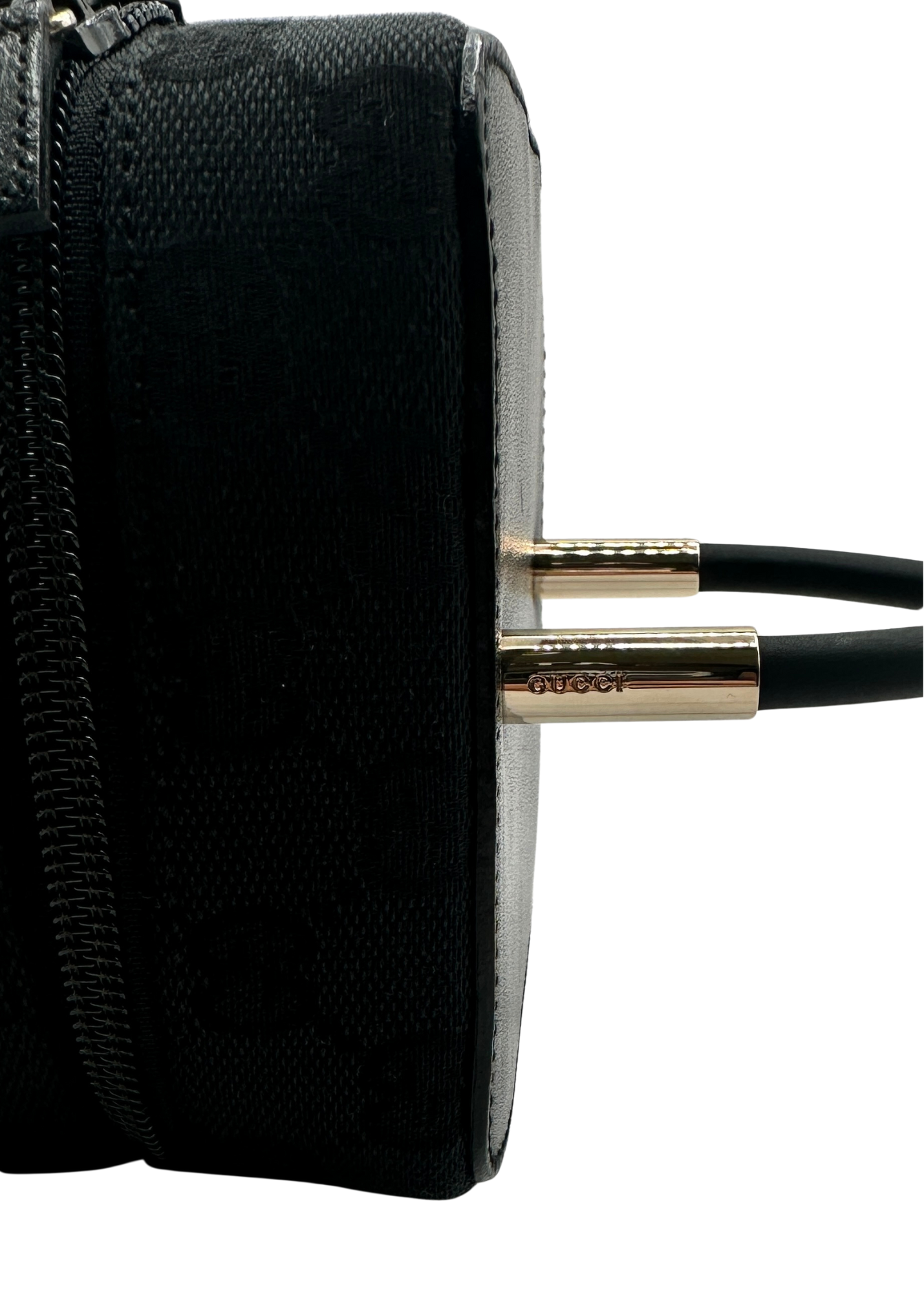 Close up of Gucci engraved logo on vintage black vanity bag