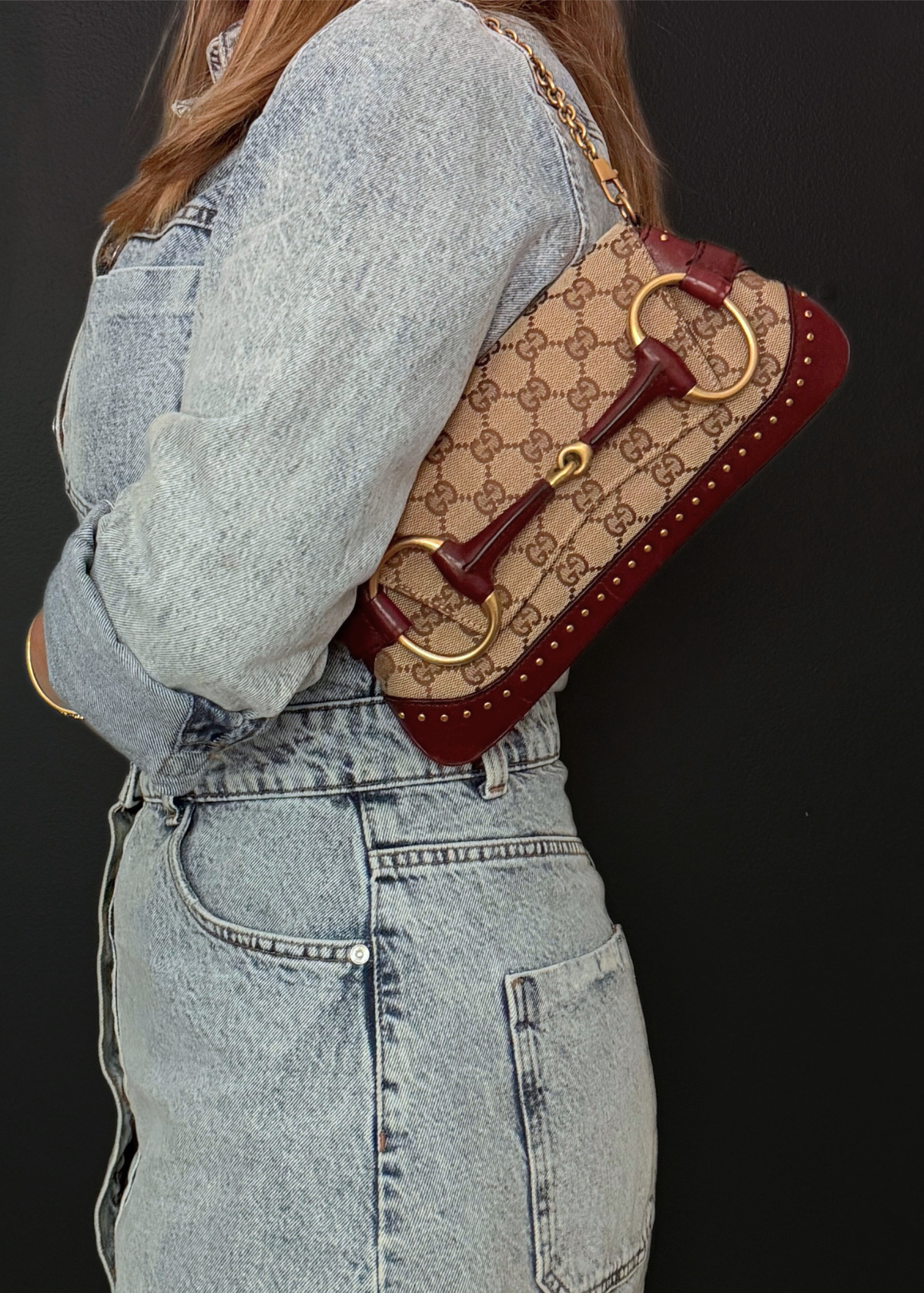 Person wearing a vintage rare Gucci Tom Ford era horsebit shoulder bag and clutch