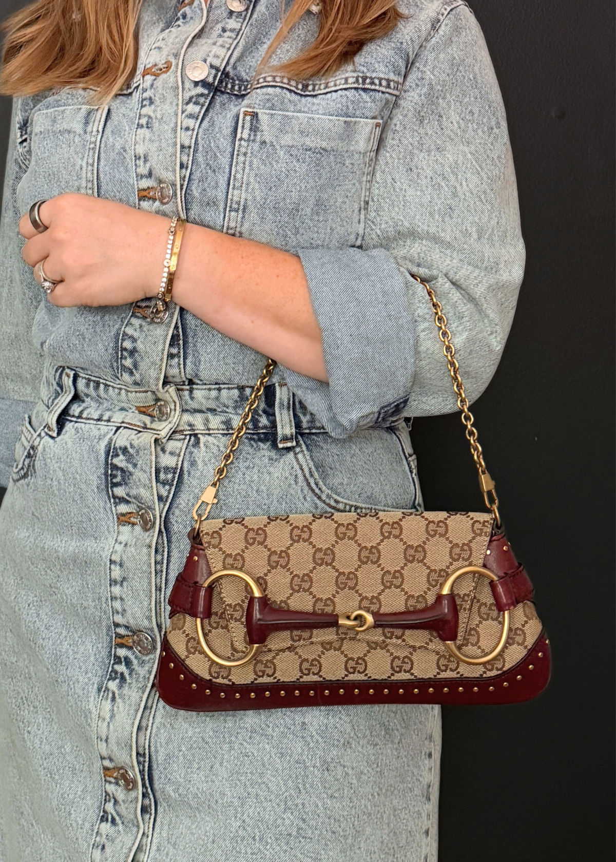 Person wearing a vintage Tom Ford Gucci horsebit clutch and shoulder bag