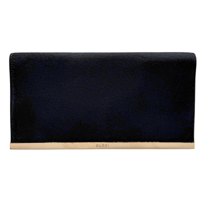 Black vintage Gucci ponyhair clutch bag with gold hardware on a white background