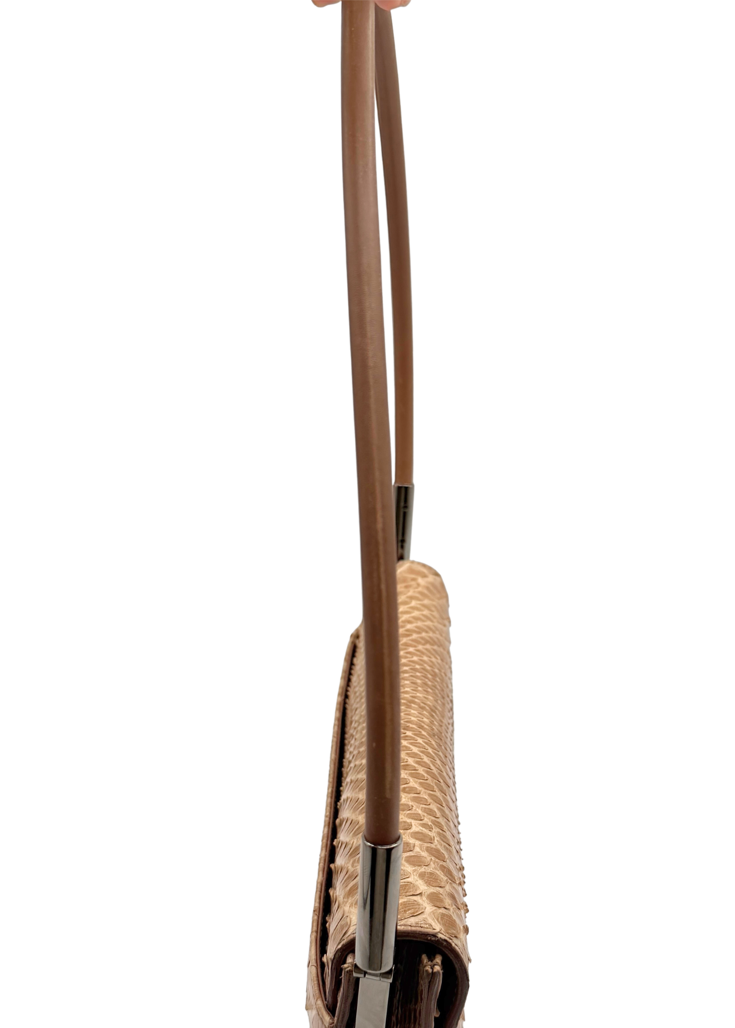 Close-up side view of a handbag with a tan textured body and a brown shoulder strap, shown against a plain white background.