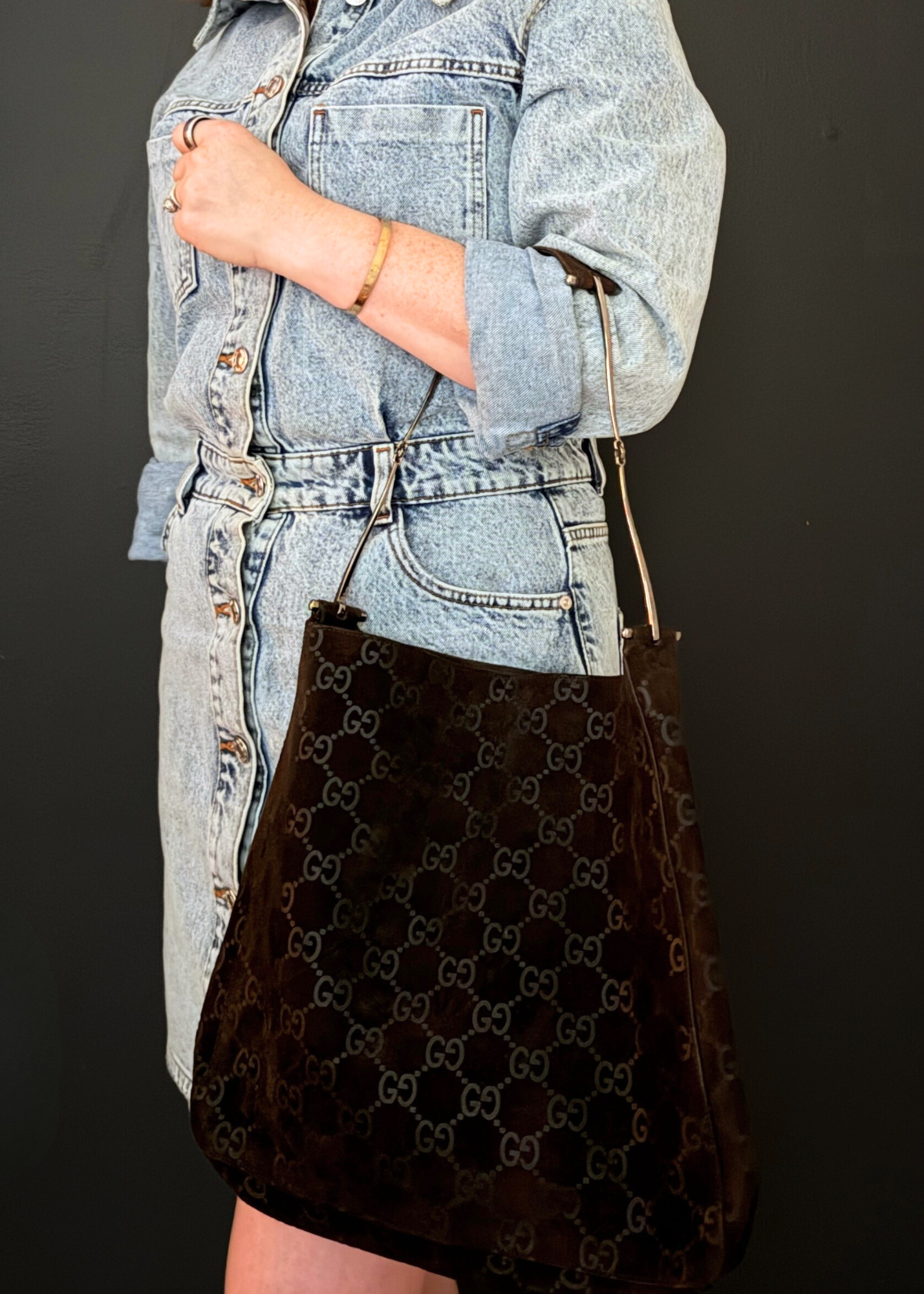 Person holding a vintage Gucci Suede shoulder bag