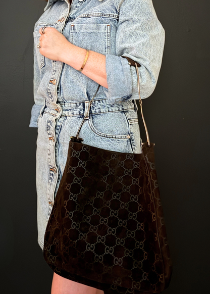 Person holding a vintage Gucci Suede shoulder bag