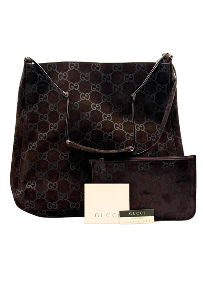 Brown Gucci handbag with matching pouch on a white background