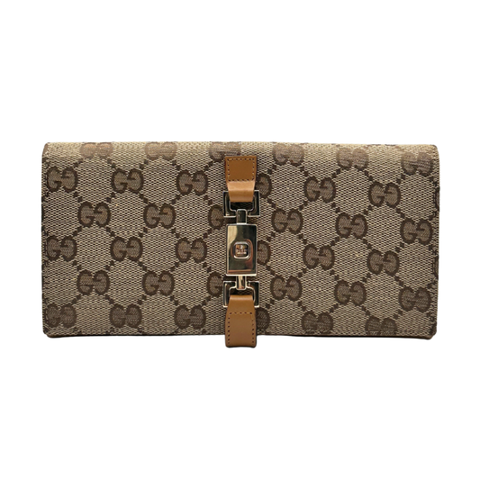 Designer wallet with Gucci monogram pattern and brown strap on a white background