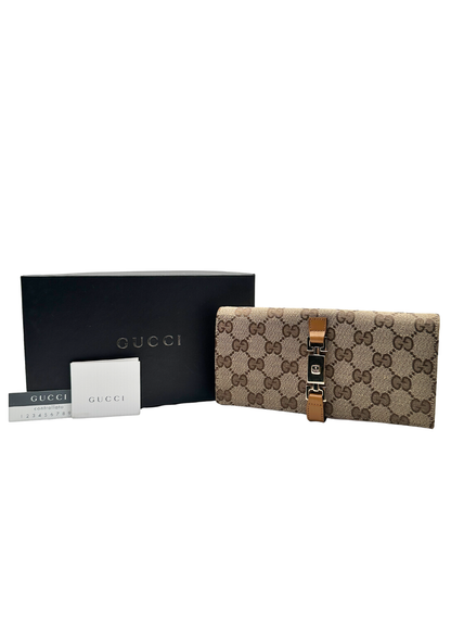 Gucci wallet with branded card and box on a white background