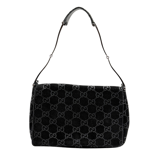 Black vintage Gucci handbag with Gucci monogram pattern on a white background