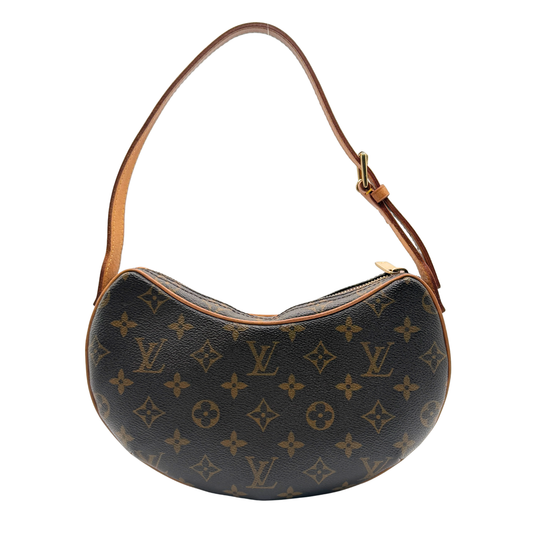 Designer Louis Vuitton handbag with LV monogram pattern on a white background