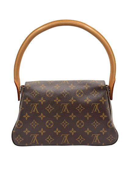 Louis Vuitton vintage designer handbag with vachetta leather handle on a white background