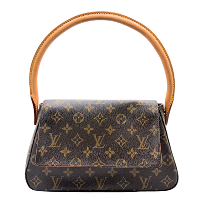 Louis Vuitton designer handbag with monogram pattern on a white background