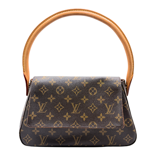 Louis Vuitton designer handbag with monogram pattern on a white background