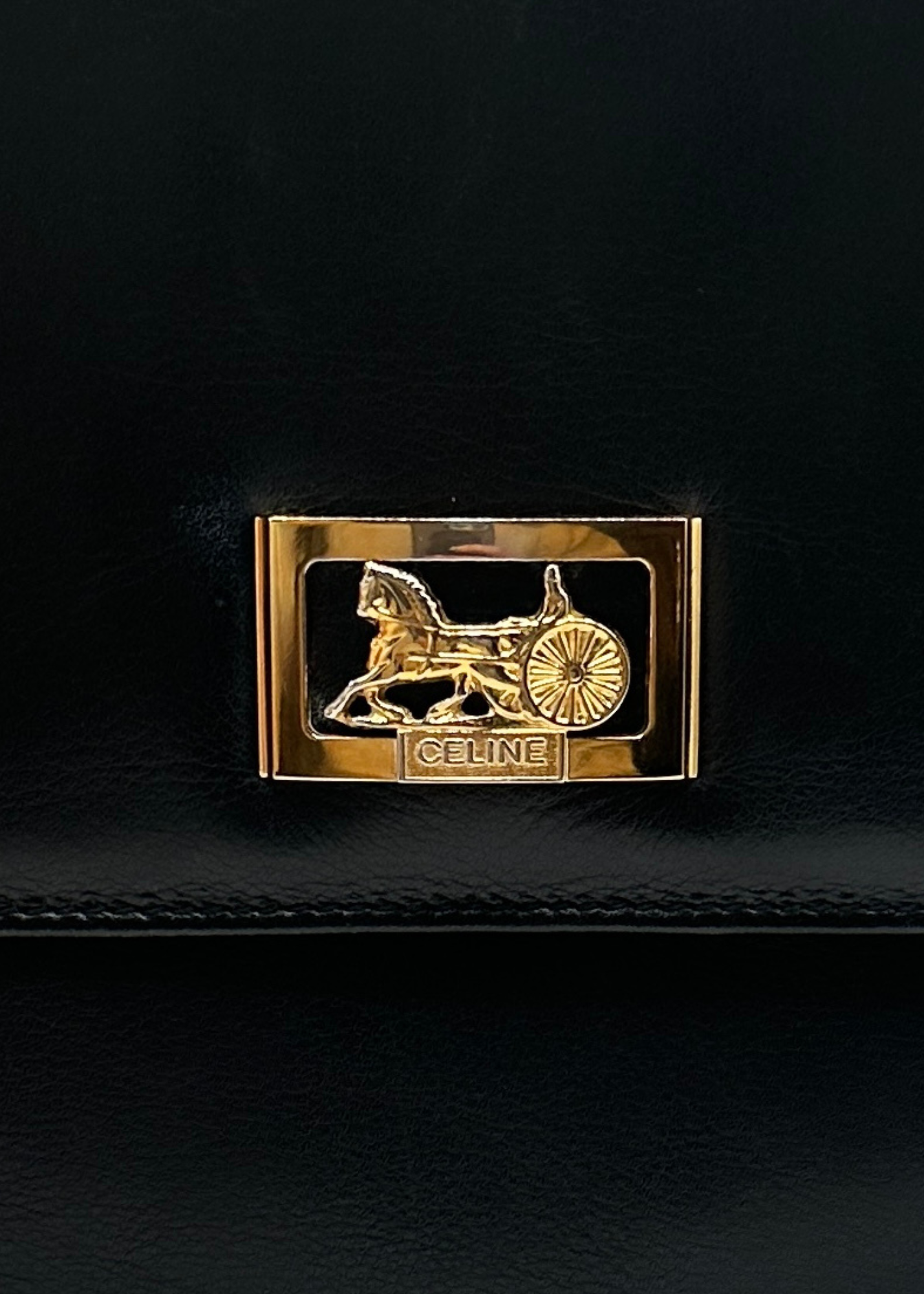 Gold Celine logo on a black background