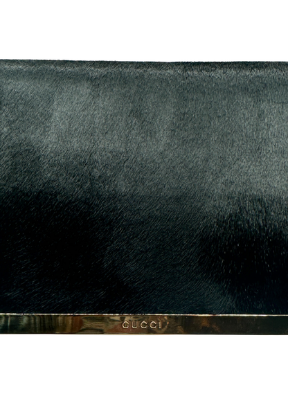 Black Gucci clutch bag with a gradient effect on a white background