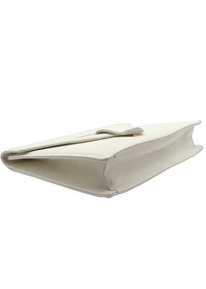 White vintage Yves Saint Laurent clutch bag on a white background