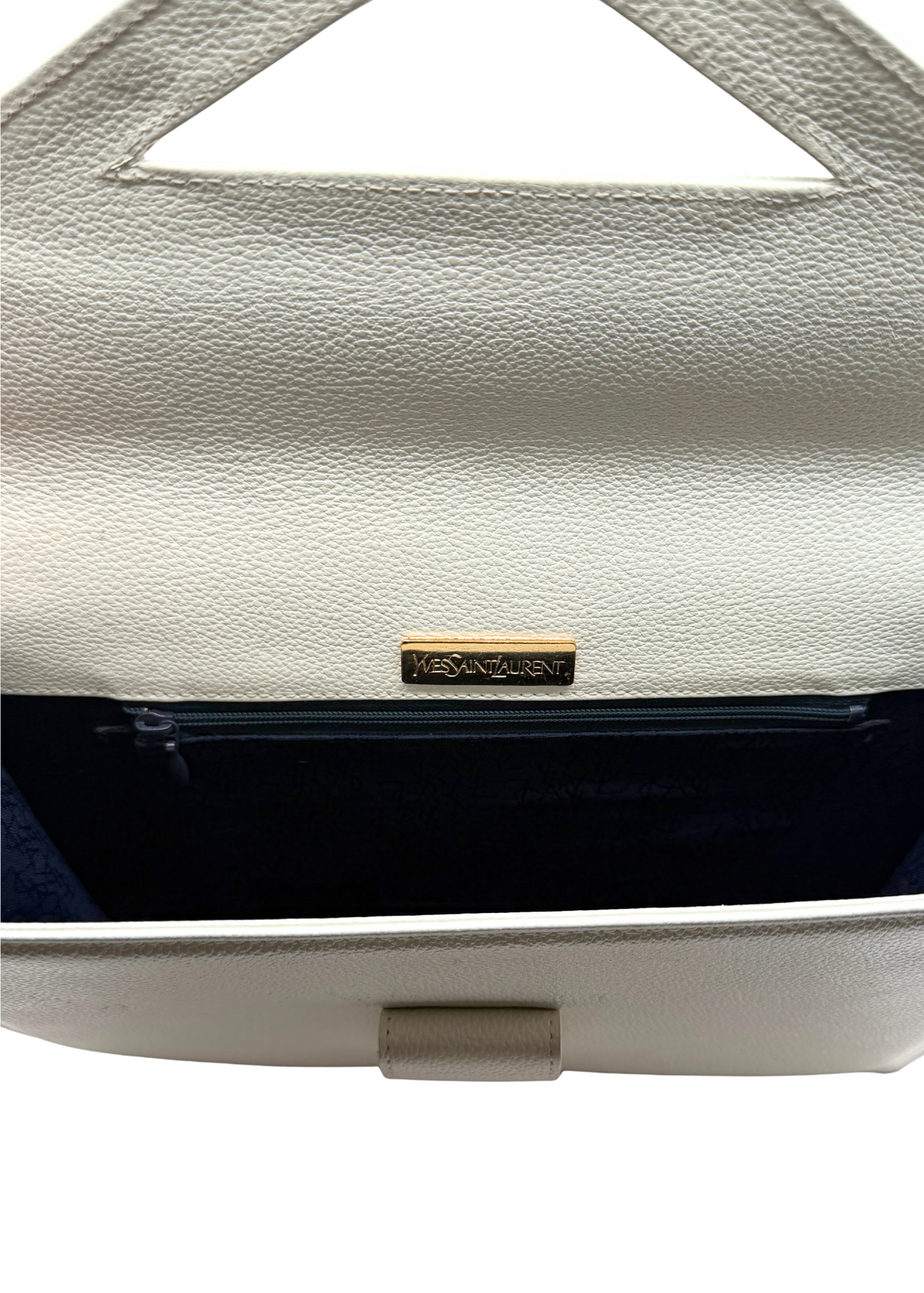 Close-up of a white vintage Yves Saint Lauret handbag with a visible brand logo on a white background