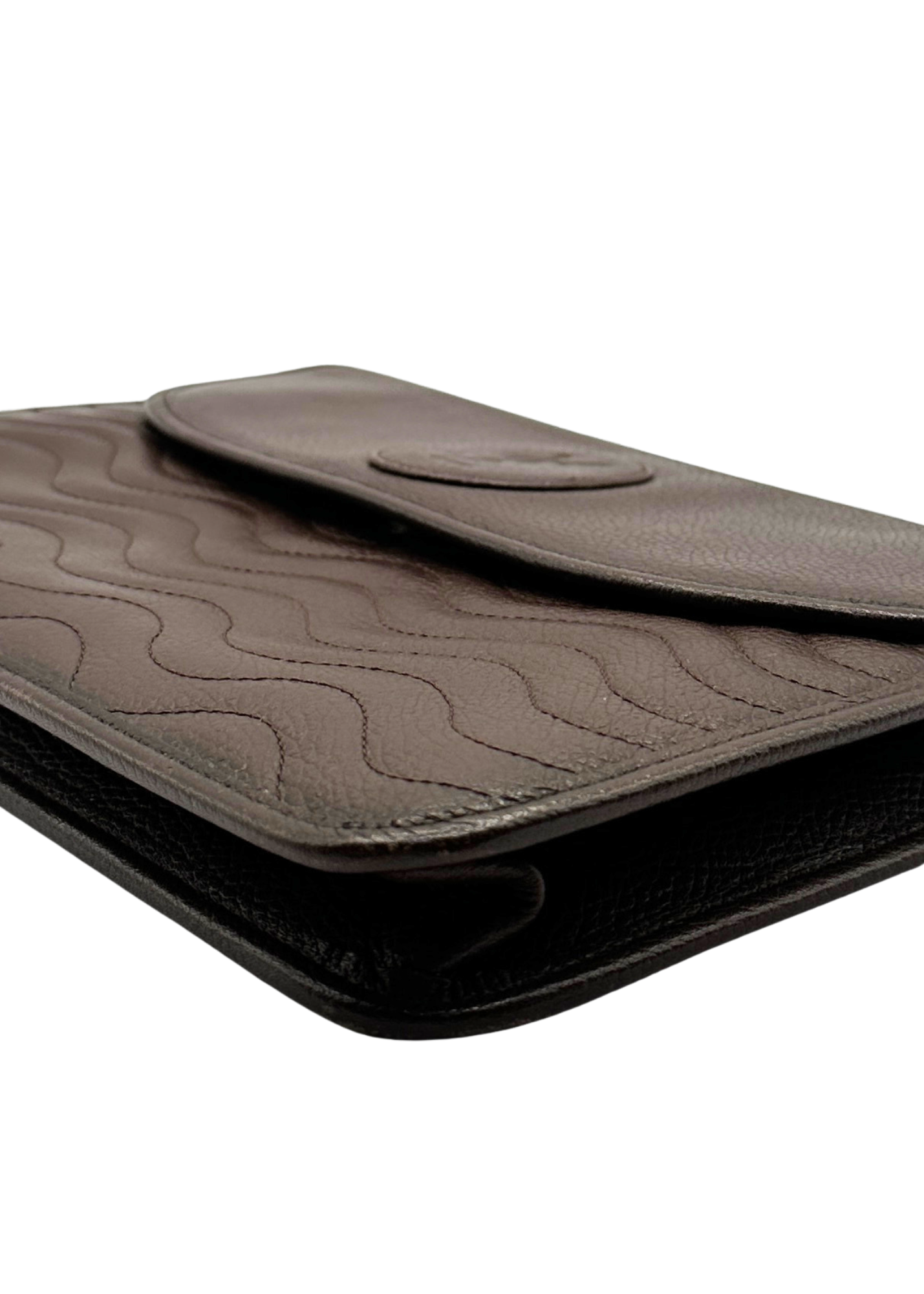 Brown leather clutch bag with a textured surface on a white background