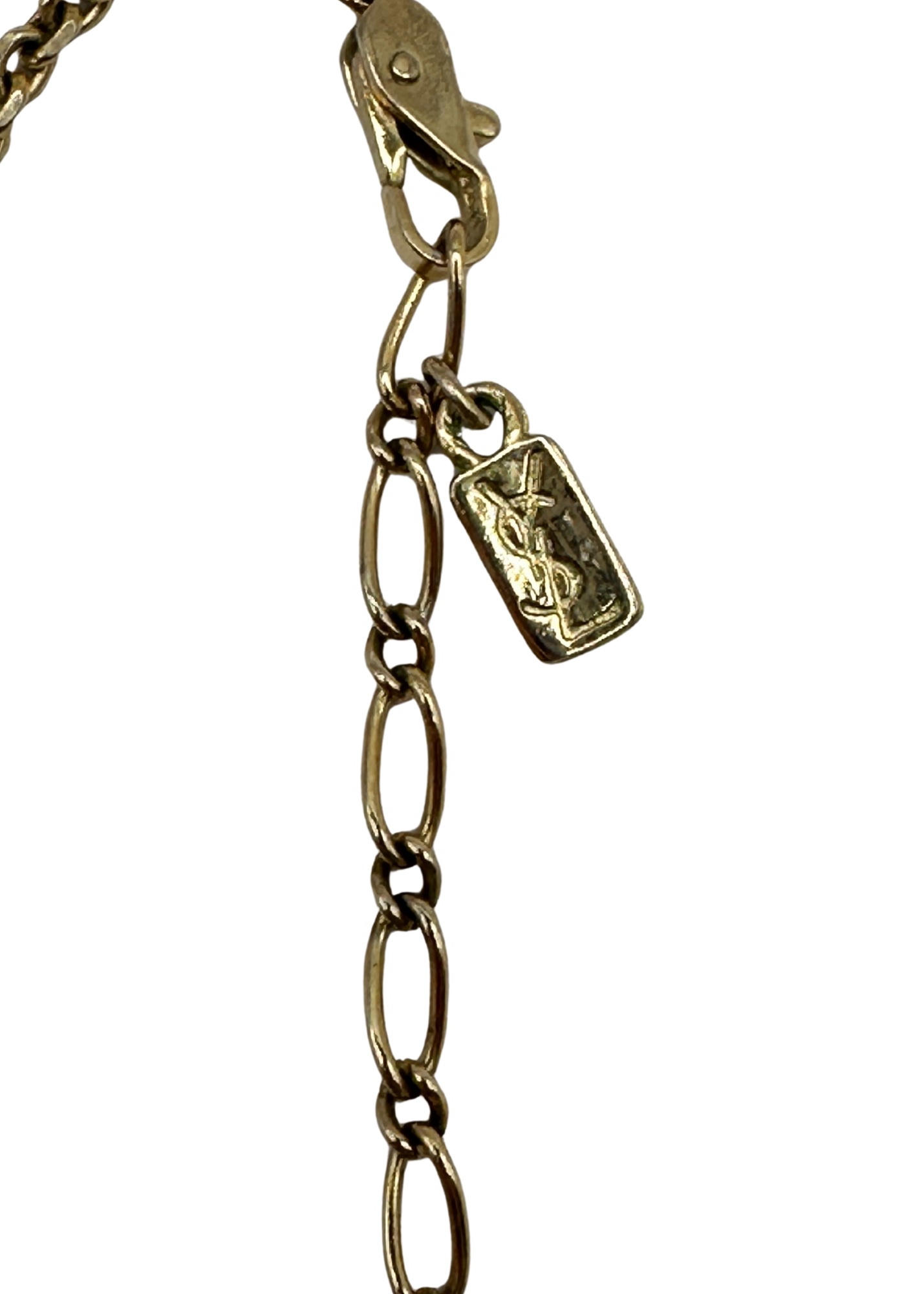 Gold chain with a YSL tag on a white background