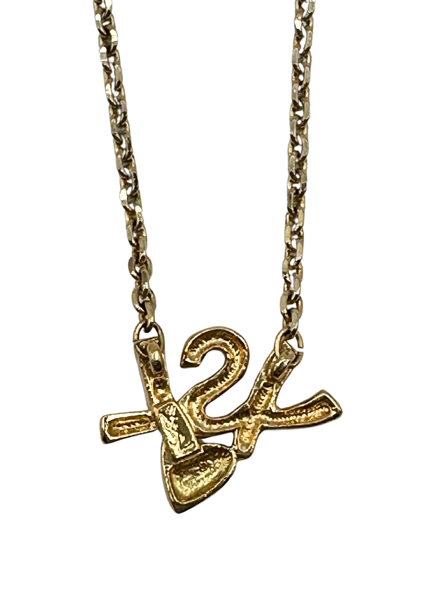 Gold necklace with a heart and YSL pendant on a white background