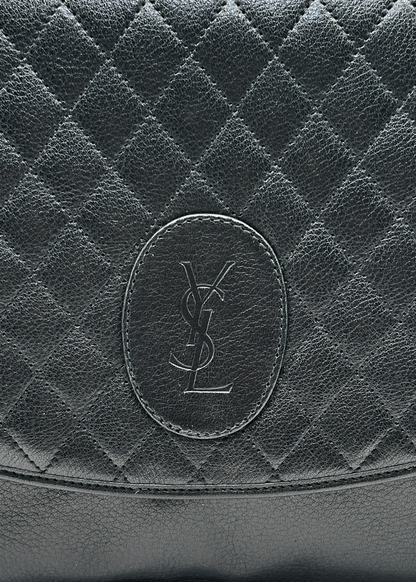 Close-up of a black quilted leather YSL bag with a brand logo.