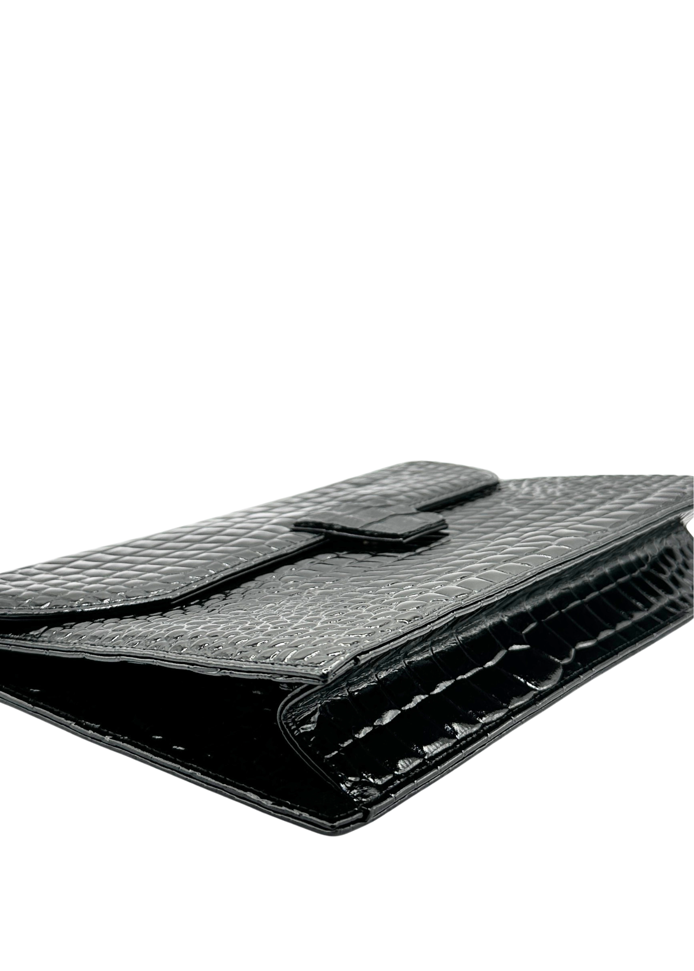 Black YSL crocodile-patterned clutch bag on a white background