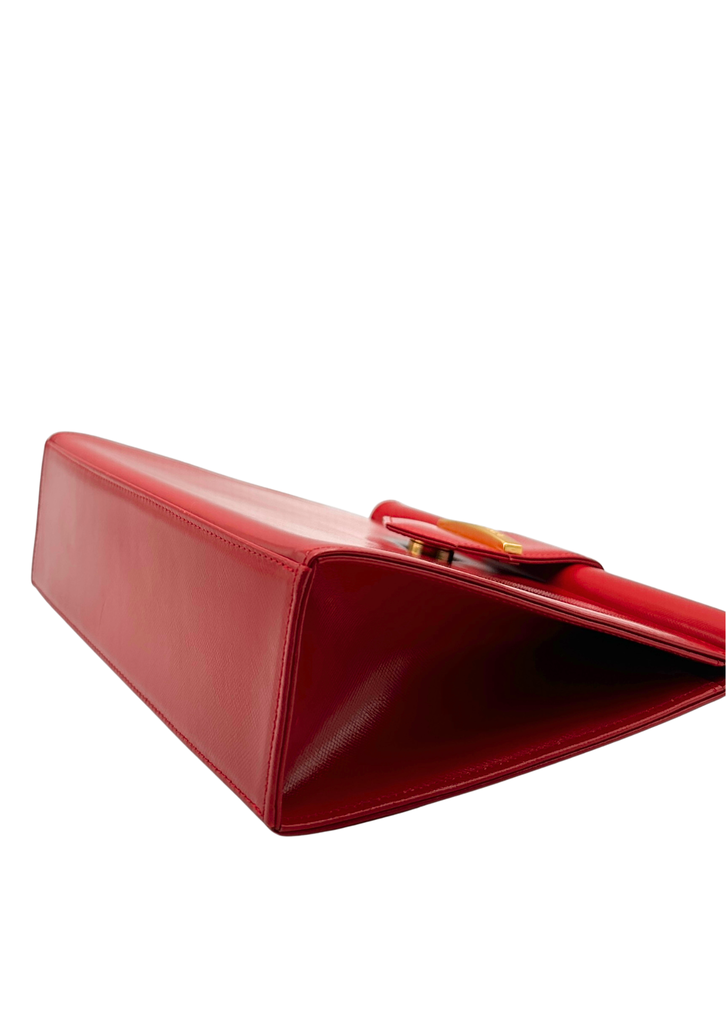 Red YSL handbag on a white background