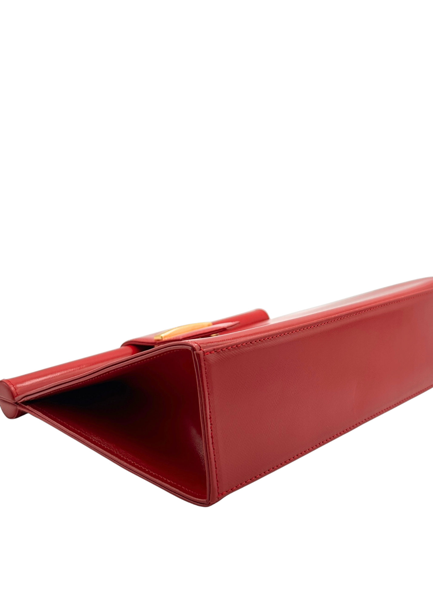 Red YSL clutch bag on a white background